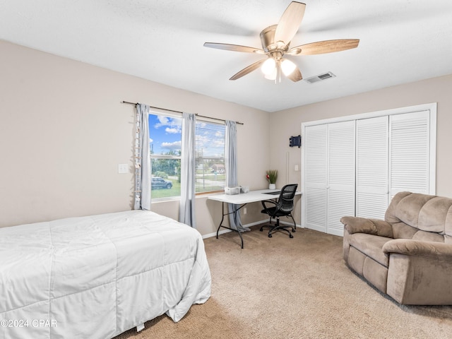 carpeted bedroom with a closet and ceiling fan