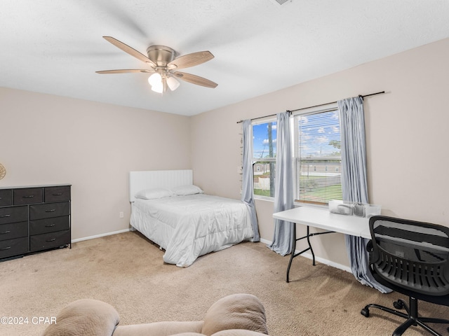 bedroom featuring ceiling fan and light carpet