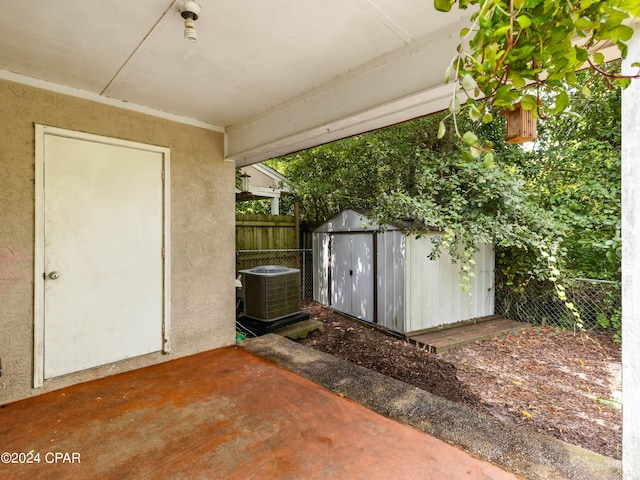 view of patio with a storage shed and cooling unit