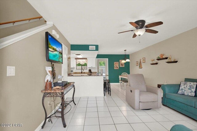 living room with ceiling fan and light tile patterned flooring