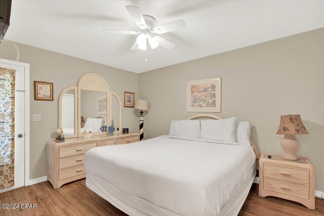 bedroom with ceiling fan and dark hardwood / wood-style floors