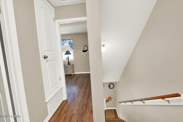 corridor with dark hardwood / wood-style floors