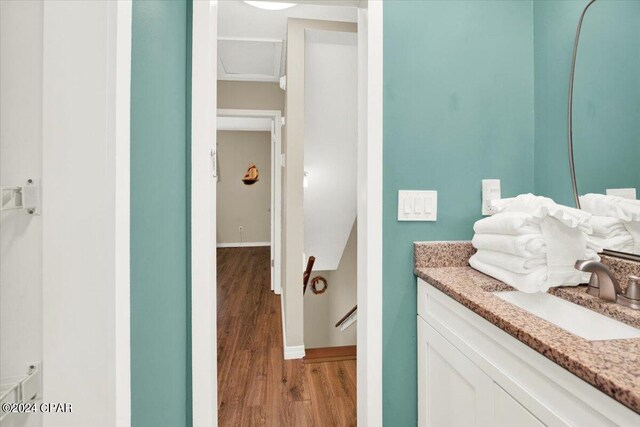 bathroom with hardwood / wood-style flooring and vanity