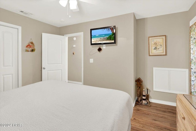 bedroom featuring ceiling fan, hardwood / wood-style flooring, and a closet