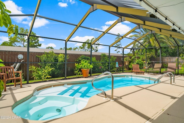 view of swimming pool featuring a lanai and a patio