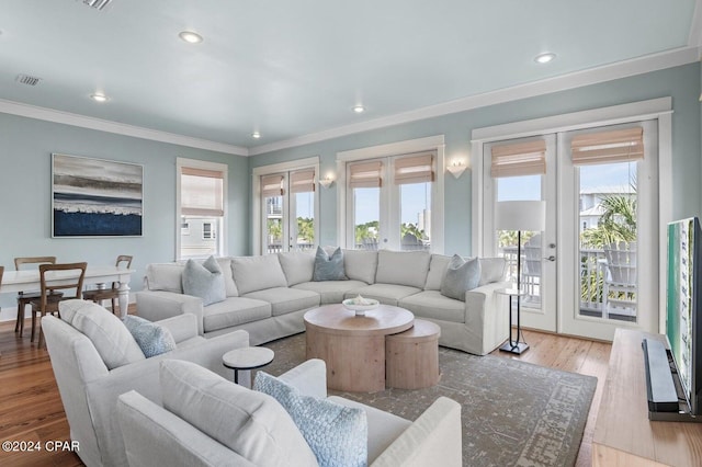 living room with crown molding, hardwood / wood-style flooring, and french doors