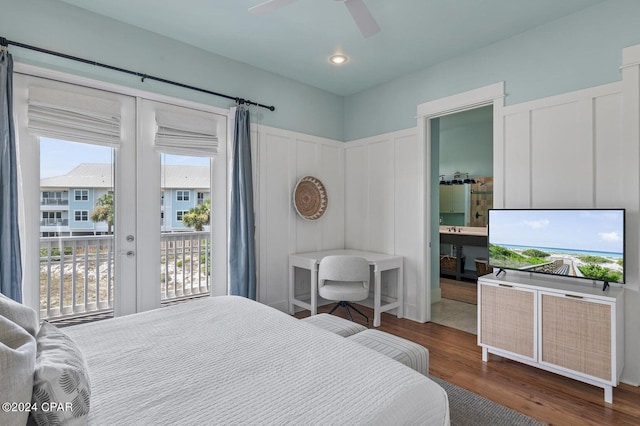 bedroom featuring wood-type flooring, ceiling fan, ensuite bath, access to outside, and french doors