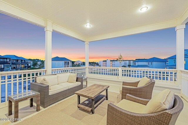 patio terrace at dusk with a balcony and outdoor lounge area