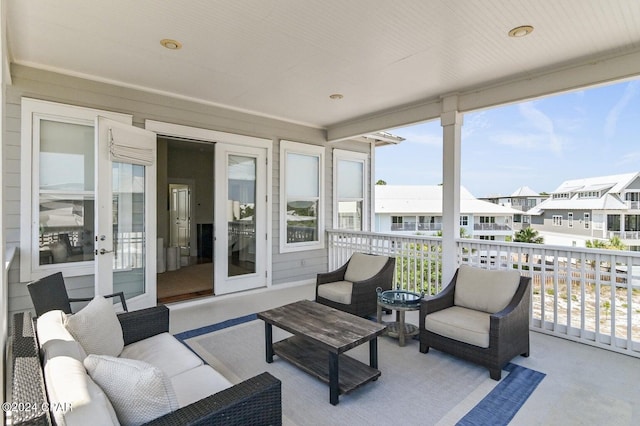 sunroom / solarium featuring french doors