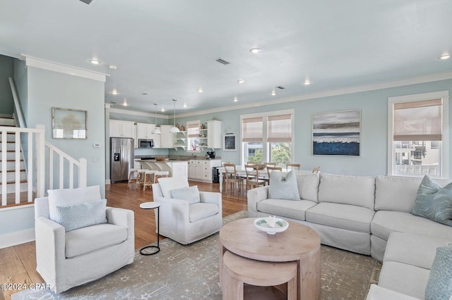 living room featuring hardwood / wood-style flooring and ornamental molding