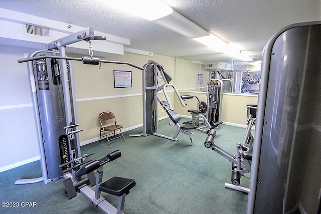 workout area with carpet and a textured ceiling