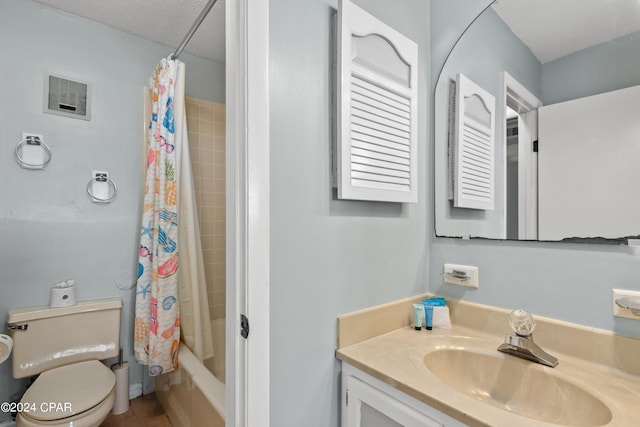 full bathroom with shower / bath combo, toilet, vanity, and a textured ceiling