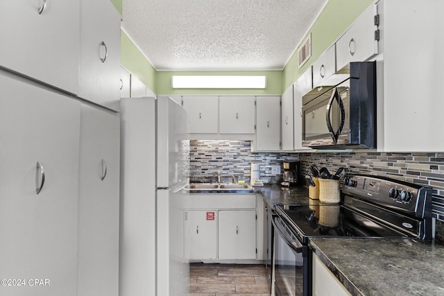 kitchen with black appliances, sink, backsplash, a textured ceiling, and dark hardwood / wood-style flooring