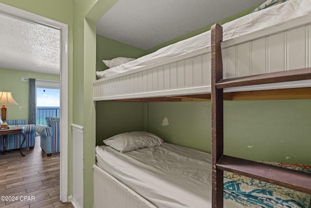 bedroom featuring a textured ceiling and wood-type flooring