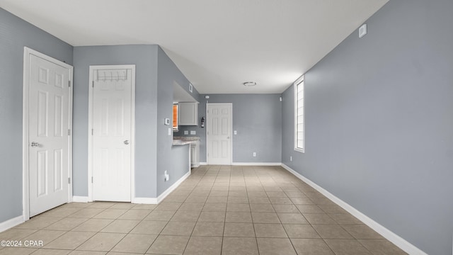 unfurnished living room featuring light tile patterned floors