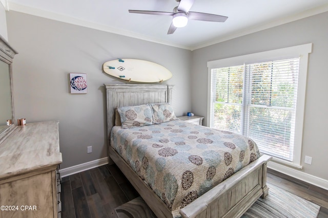 bedroom featuring ceiling fan, ornamental molding, and dark hardwood / wood-style floors