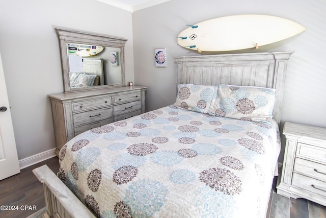 bedroom featuring dark wood-type flooring and crown molding