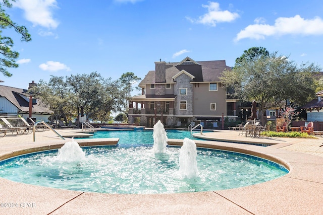 view of pool featuring pool water feature and a patio area