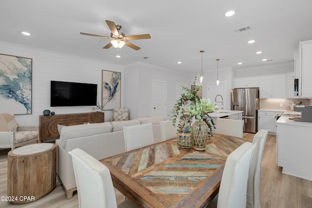 dining area featuring ceiling fan, ornamental molding, and light hardwood / wood-style flooring