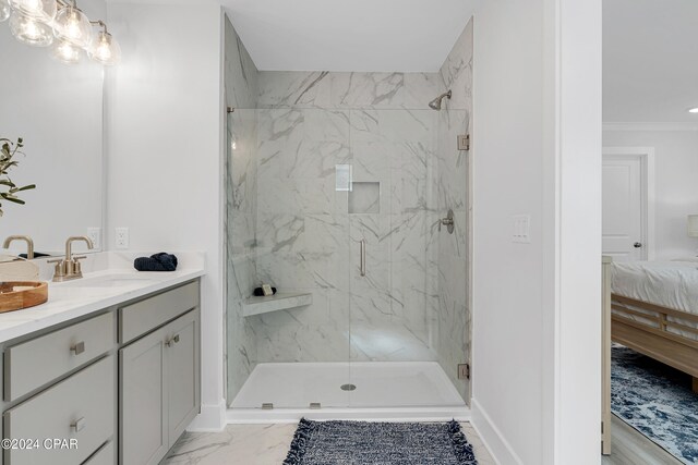 bathroom featuring vanity, a shower with shower door, and ornamental molding