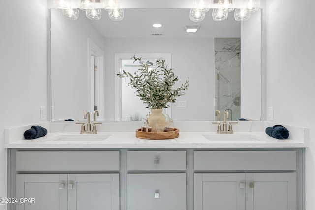 bathroom featuring vanity and a shower with shower door