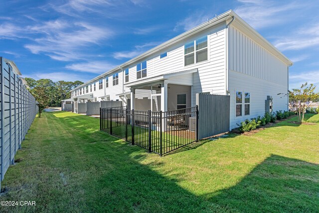 back of property featuring a lawn