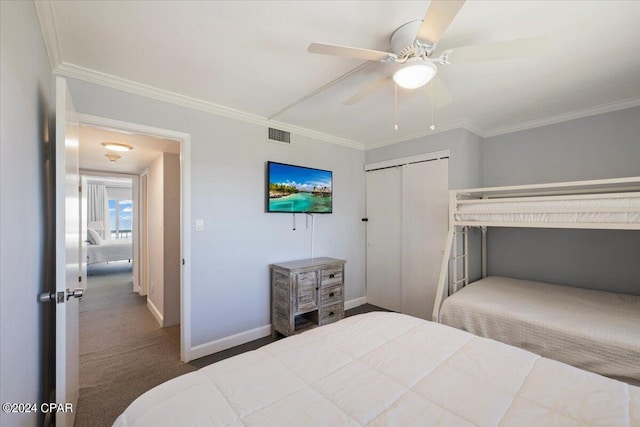 carpeted bedroom featuring a closet, ceiling fan, and ornamental molding