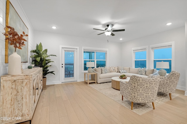 living room featuring ceiling fan and light wood-type flooring