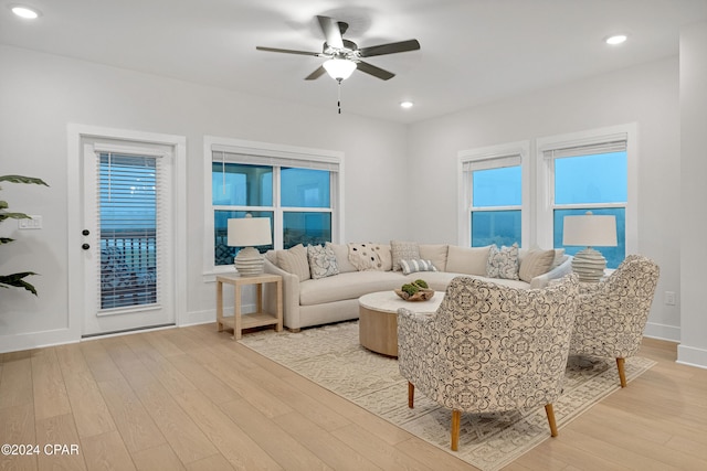 living room with light wood-type flooring and ceiling fan