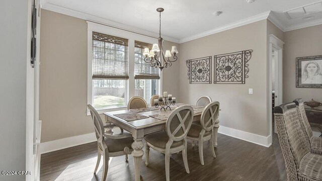 dining room with dark wood-type flooring, a chandelier, and ornamental molding