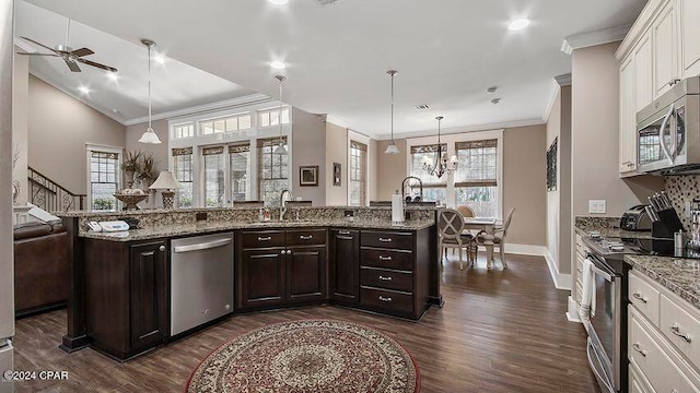 kitchen featuring white cabinets, ceiling fan with notable chandelier, stainless steel appliances, and plenty of natural light