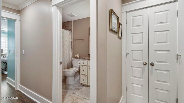 bathroom with vanity, a shower with shower curtain, wood-type flooring, crown molding, and toilet