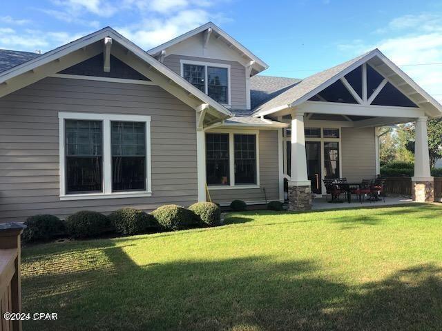 back of house featuring a yard and a patio area