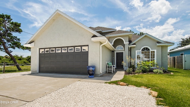 view of front facade featuring a front yard and a garage