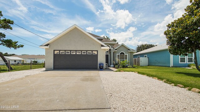 view of front facade with a front lawn and a garage