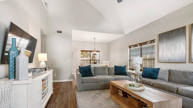 living room featuring high vaulted ceiling and light wood-type flooring