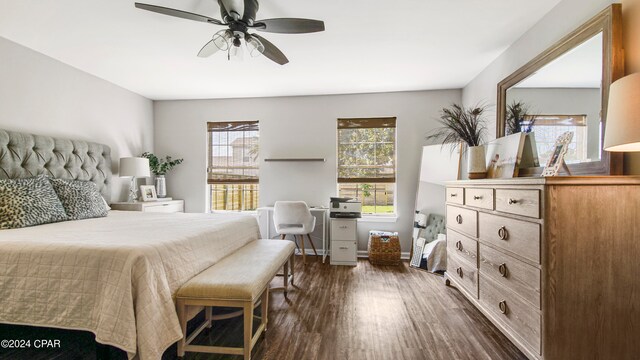 bedroom featuring dark wood-type flooring, multiple windows, and ceiling fan