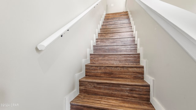 stairway with hardwood / wood-style flooring