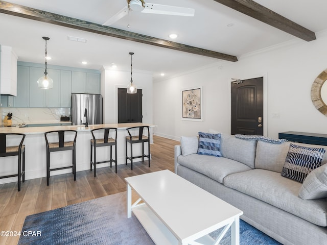 living room with beam ceiling, dark wood-type flooring, and crown molding