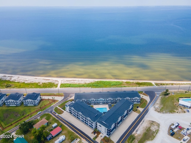 bird's eye view featuring a water view and a beach view