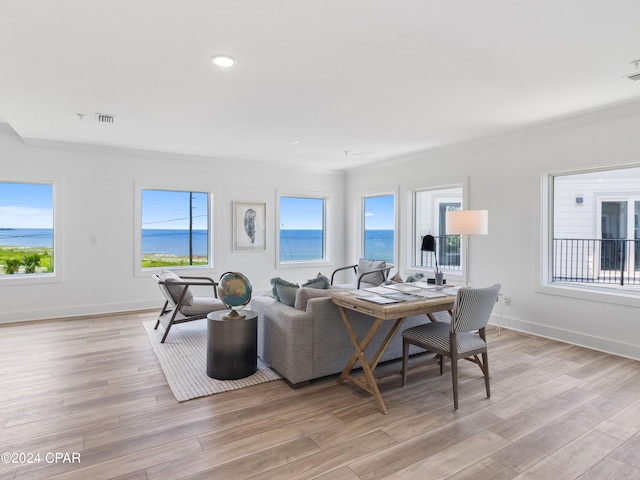 living room with a water view and light wood-type flooring