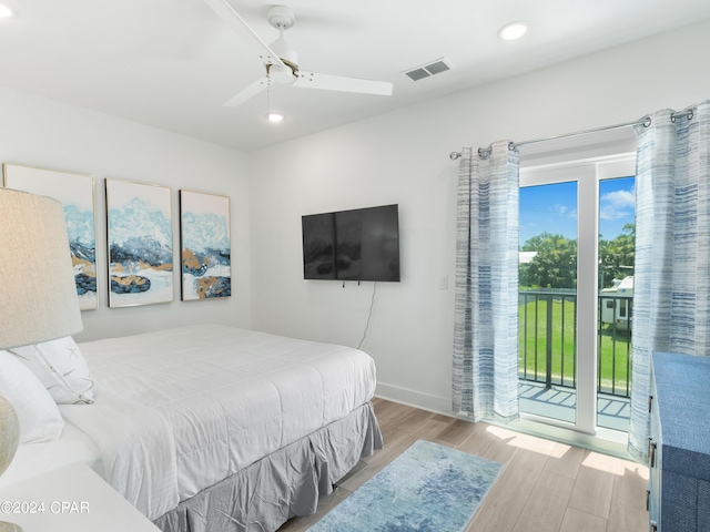 bedroom featuring light hardwood / wood-style flooring, access to exterior, and ceiling fan