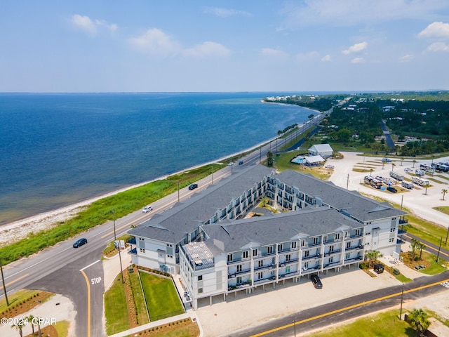 birds eye view of property with a water view and a view of the beach