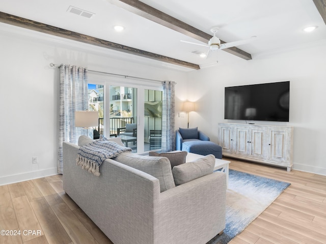 living room with beam ceiling, light wood-type flooring, and ceiling fan