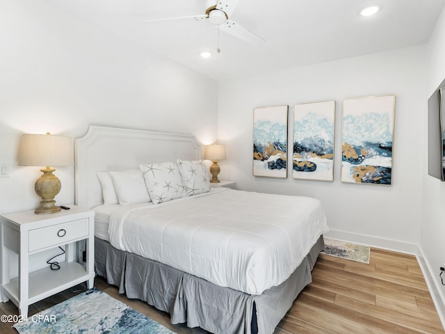 bedroom with light hardwood / wood-style floors and ceiling fan