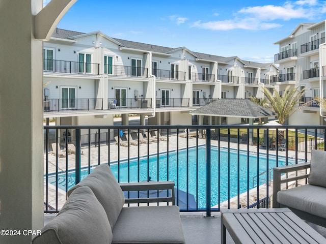 view of swimming pool with an outdoor living space and a patio area