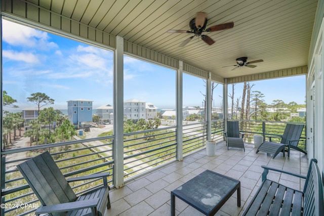 sunroom featuring ceiling fan