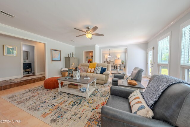 living room with ceiling fan, crown molding, and tile patterned floors