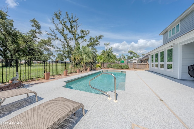 view of swimming pool with a patio area