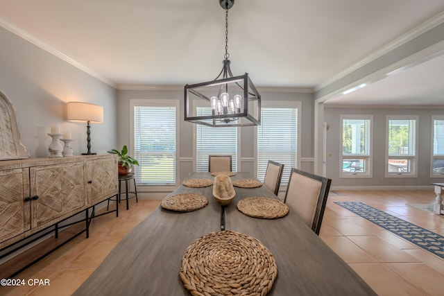 tiled dining room with a notable chandelier and crown molding